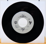 Vinyl record with a white label featuring Eric Clapton's name on a white background