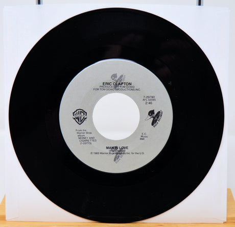Vinyl record with a white label featuring Eric Clapton's name on a white background