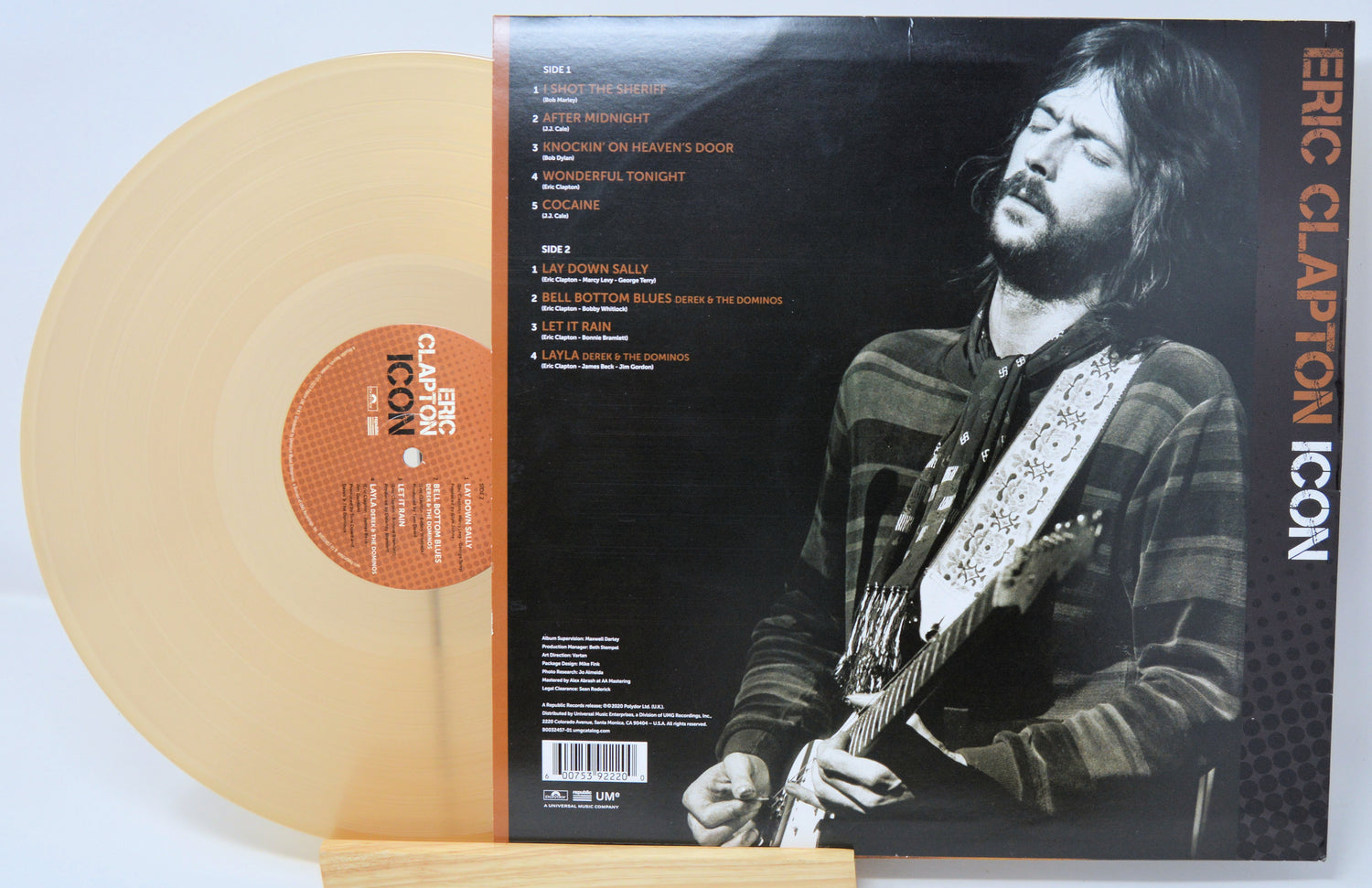 Vinyl record with a cover featuring Eric Clapton playing guitar, on a light blue background.