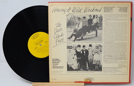 Vinyl record with yellow label and cover featuring text and images of a band.