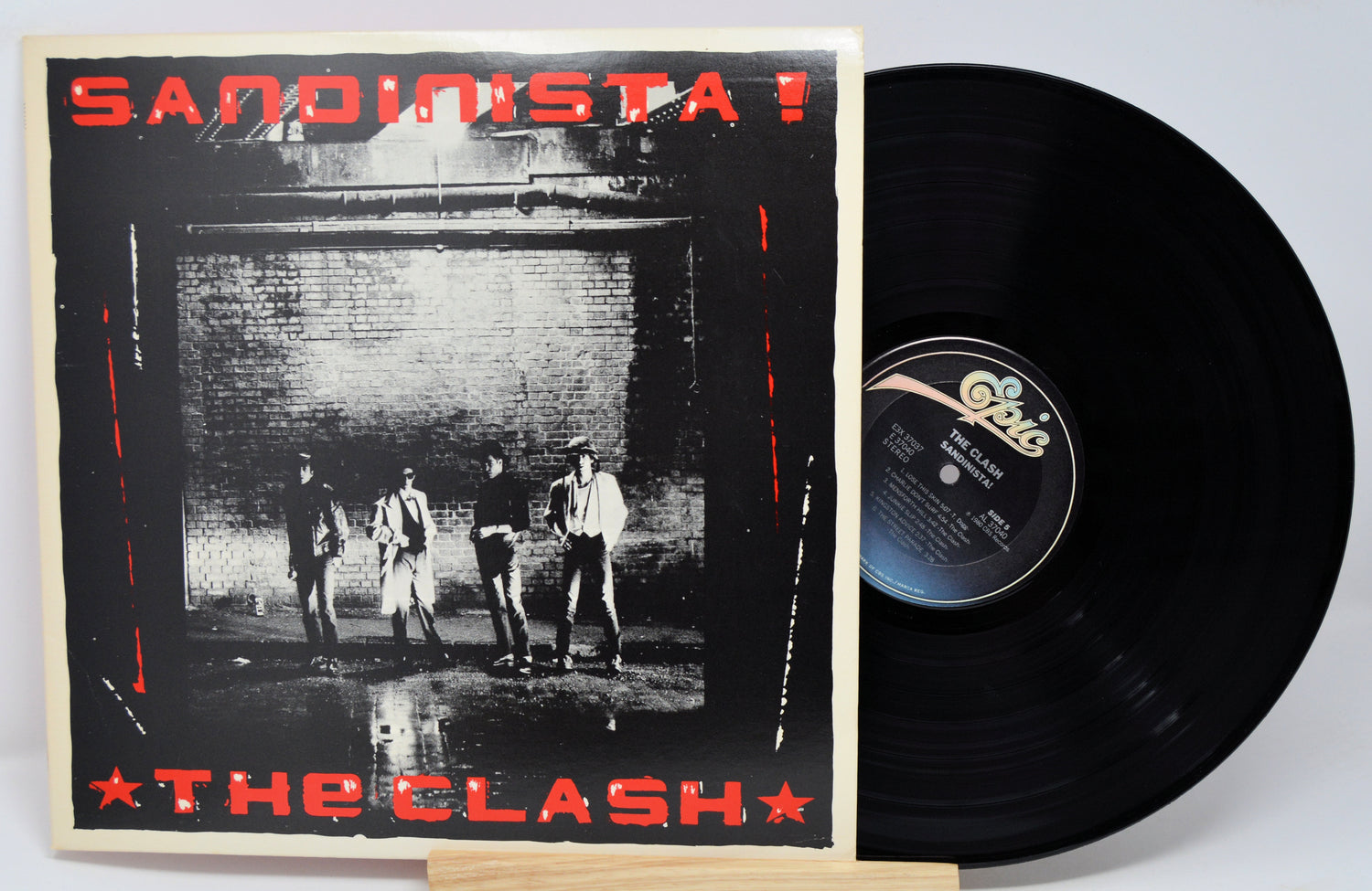 Vinyl record and cover of 'Sandinista!' by The Clash on a white background
