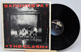 Vinyl record and cover of 'Sandinista!' by The Clash on a white background