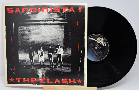 Vinyl record and cover of 'Sandinista!' by The Clash on a white background