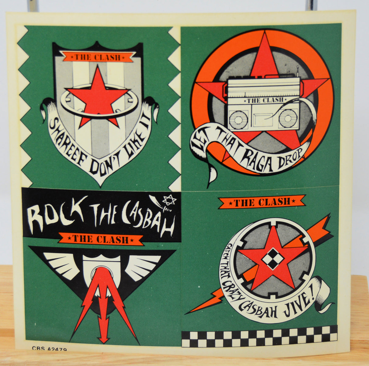 Collection of The Clash stickers on a green background