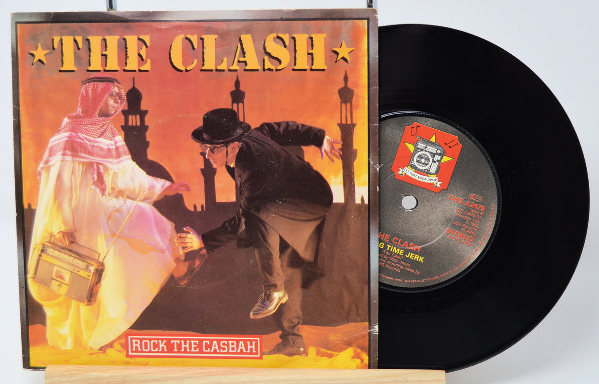 Vinyl record and cover of 'The Clash - Rock The Casbah' on a white background