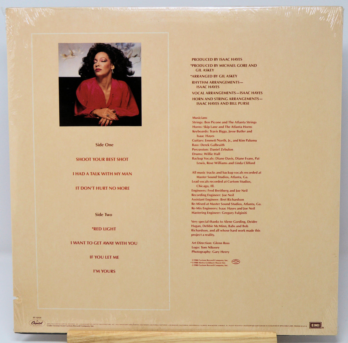 Back cover of a vinyl record with text and a photo of a person.