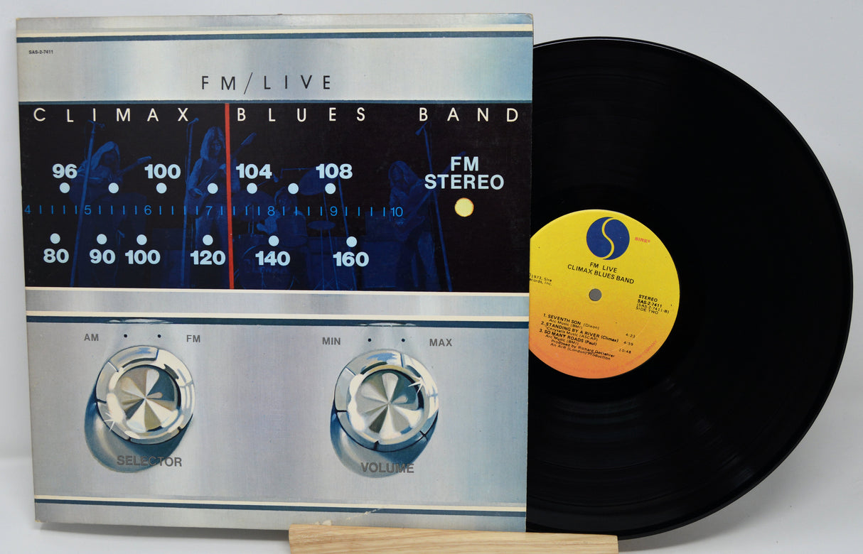 Vinyl record with a cover featuring an FM radio design.