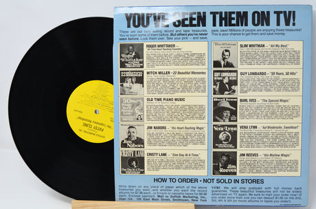 Vinyl record with a colorful sleeve featuring text and images of people, on a light gray background.