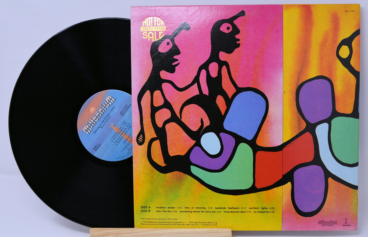 Vinyl record with colorful cover featuring abstract human figures on a white background