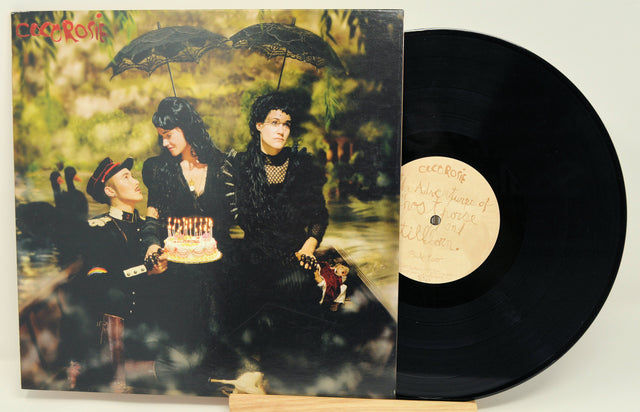 Front cover of CocoRosie’s 'The Adventures of Ghosthorse and Stillborn' vinyl album with band members in costume holding a birthday cake