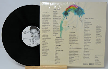 Back cover and vinyl record of CocoRosie's 'La Maison de Mon Rêve' LP, featuring lyric sheet and rainbow artwork