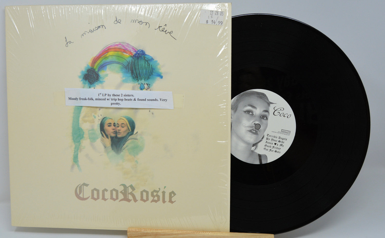 Front cover and vinyl record of CocoRosie's 'La Maison de Mon Rêve' debut LP with artwork of two sisters under a rainbow