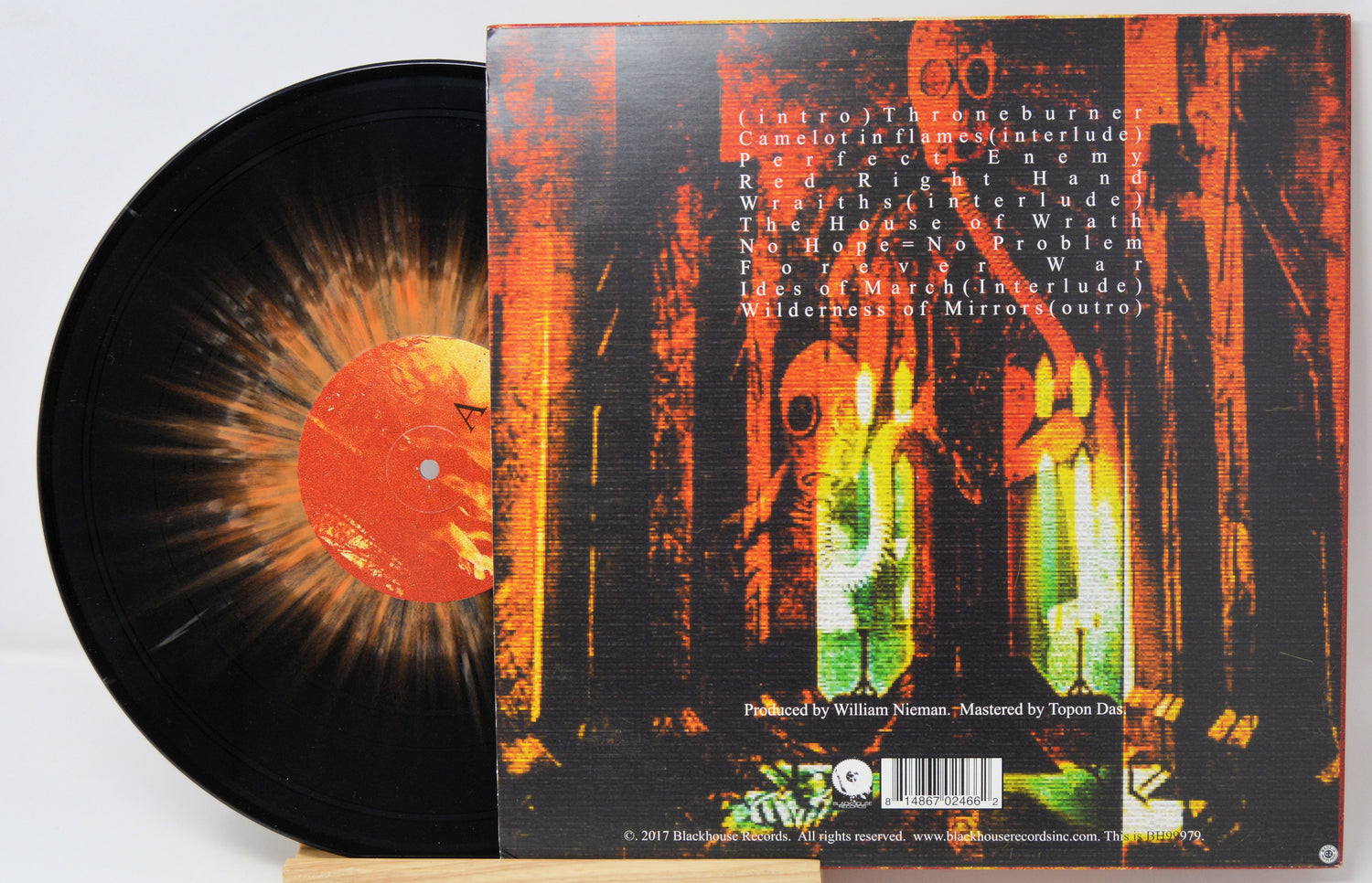 Vinyl record with a colorful cover featuring abstract designs and text.
