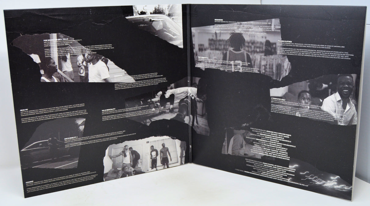 Open book with black and white photographs and text on a white surface