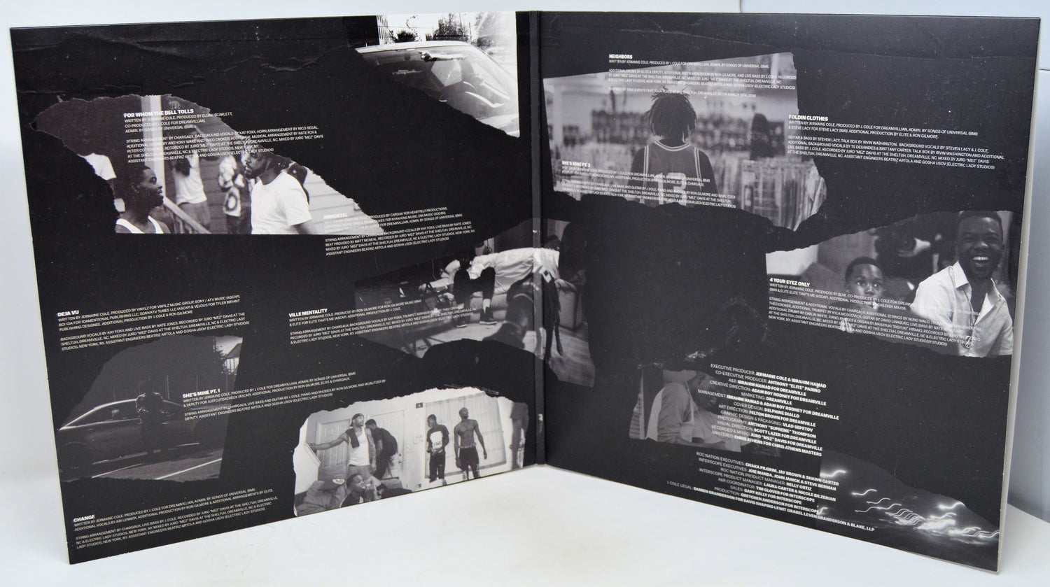 Open book with black and white photographs and text on a white surface