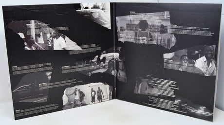 Open book with black and white photographs and text on a white surface