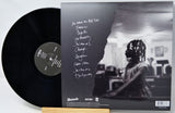Vinyl record with a black and white photo of a person on the cover