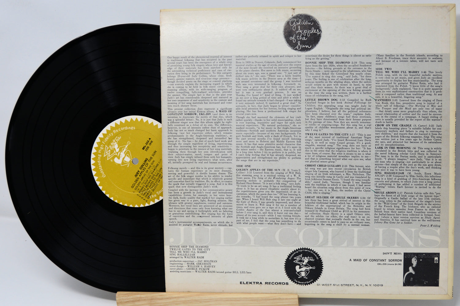 Vinyl record with its cover featuring text and a label on a light gray background