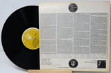 Vinyl record with its cover featuring text and a label on a light gray background