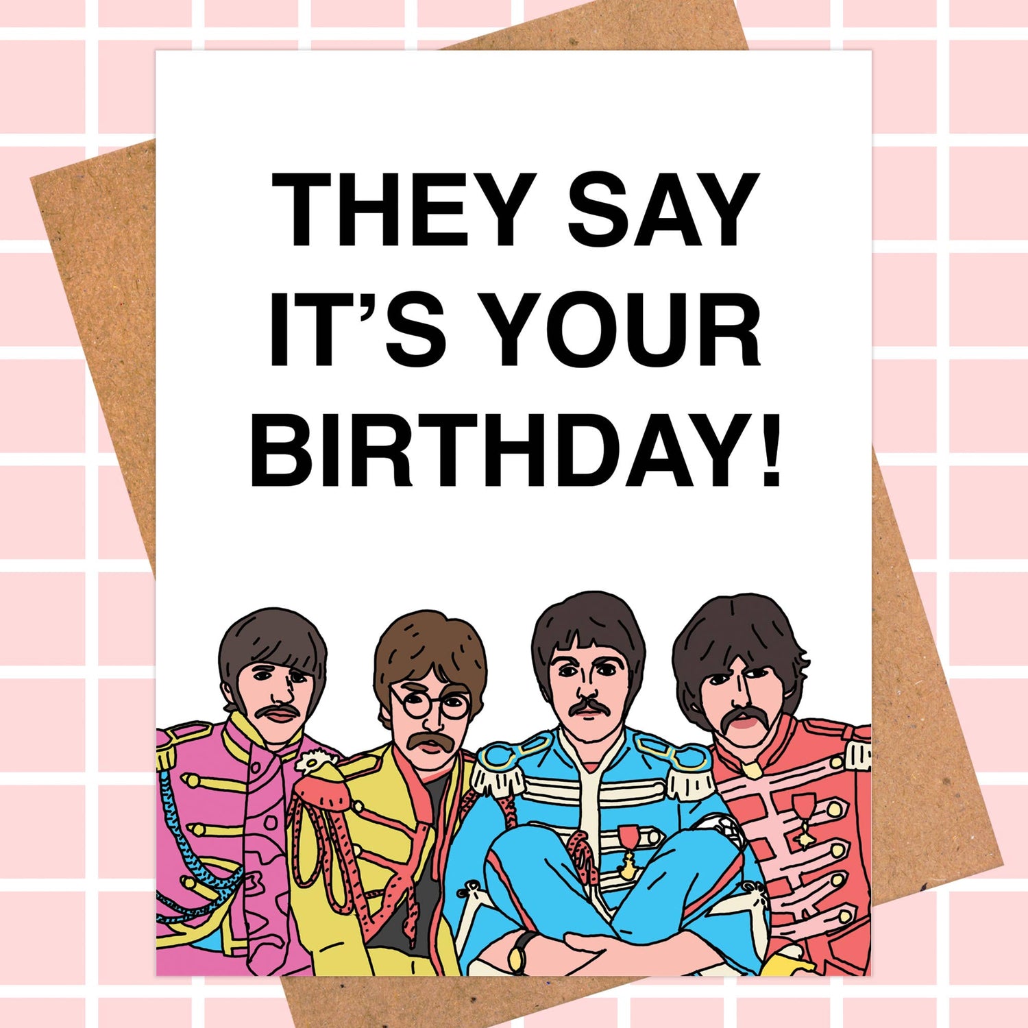 Birthday card featuring a cartoon of four band members in colorful Sgt. Pepper-style outfits with the message 'They Say It's Your Birthday!'