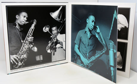 A set of black and white photographic prints displayed in an open photo album or binder. The prints feature jazz musicians playing saxophones and trumpets, with one print rendered in a strong blue-green tint.