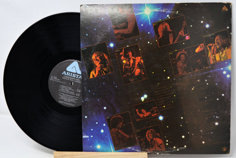 Vinyl record with a colorful cover featuring images of a person and the Arista Records logo.