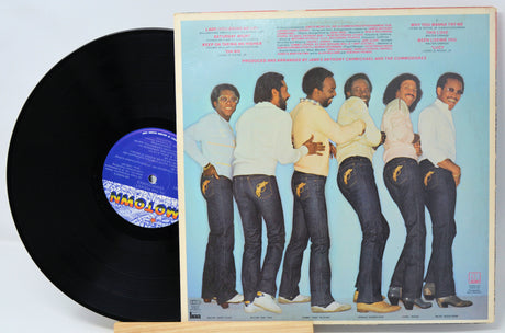 Vinyl record with a colorful cover featuring five people and the word 'Inmoloy'.