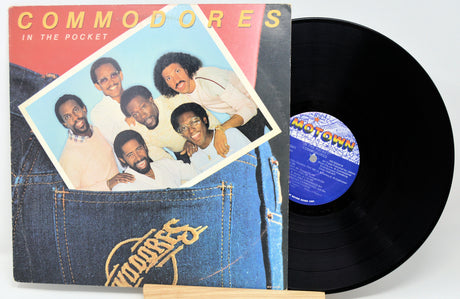 Vinyl record with cover featuring a group of people and 'Commodores' branding.