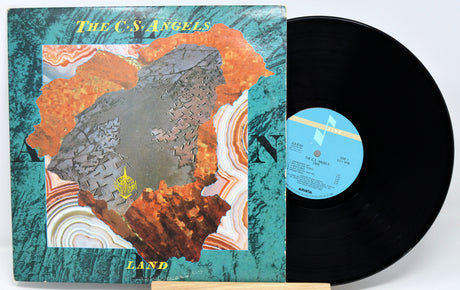 Vinyl record and cover with 'The C.S. Angels' album titled 'Land'.
