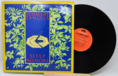 Vinyl record with 'Comsat Angels' album cover featuring blue and yellow design.