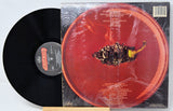 Vinyl record with a red cover featuring a close-up of a pepper.