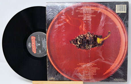Vinyl record with a red cover featuring a close-up of a pepper.