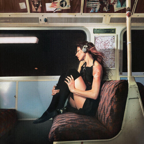 Porcupine Tree Closure / Continuation album cover featuring woman listening to headphones on a subway seat