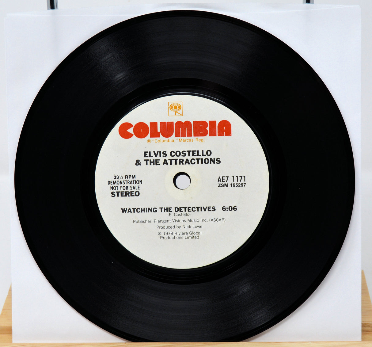 Vinyl record with 'Columbia' label featuring Elvis Costello & The Attractions on a white background