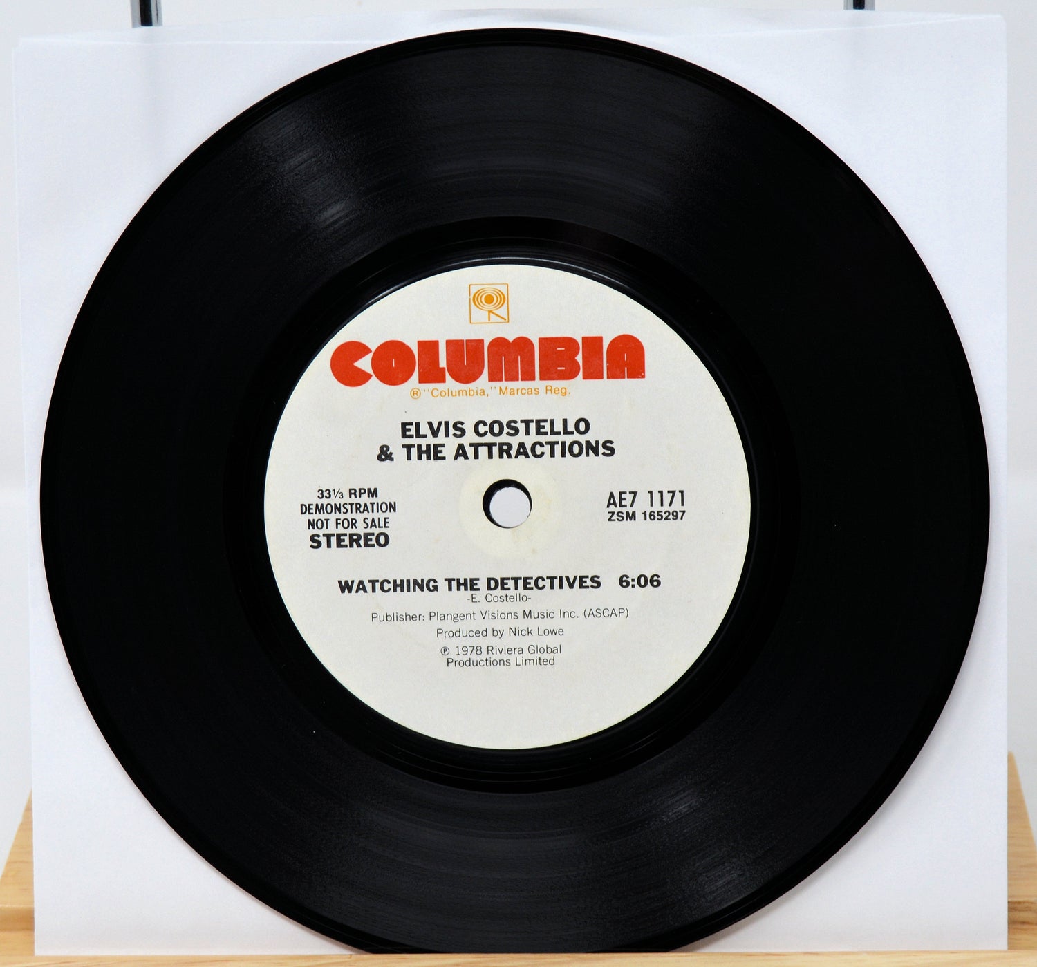 Vinyl record with 'Columbia' label featuring Elvis Costello & The Attractions on a white background