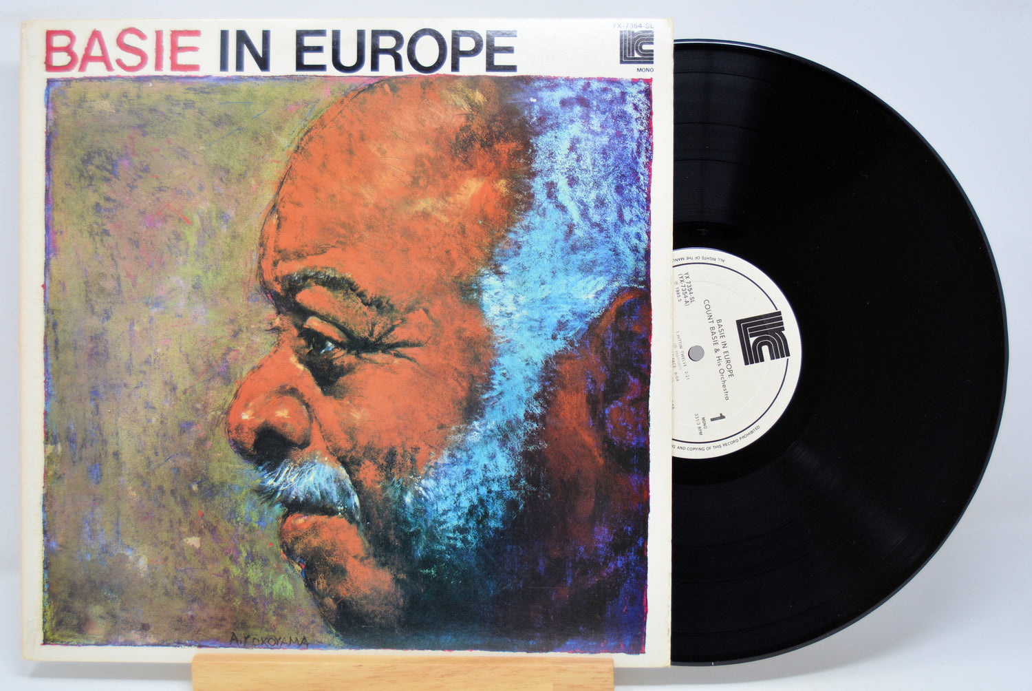 Vinyl record with cover featuring a stylized portrait of a man, labeled 'Basie in Europe'.