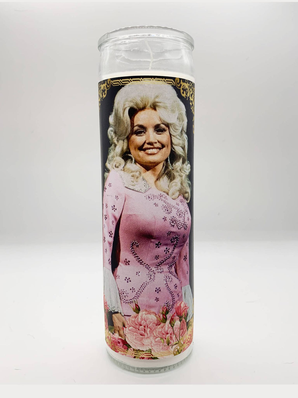 Decorative prayer candle featuring a smiling country singer in a pink outfit with floral accents