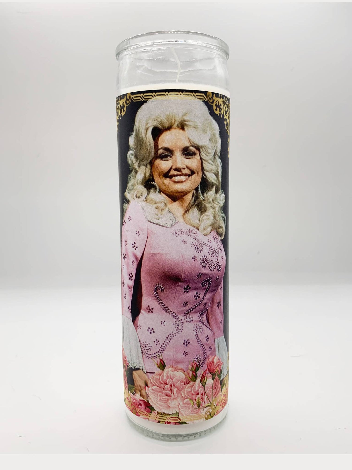 Decorative prayer candle featuring a smiling country singer in a pink outfit with floral accents