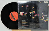 Vinyl record with cover featuring artistic design on a white background