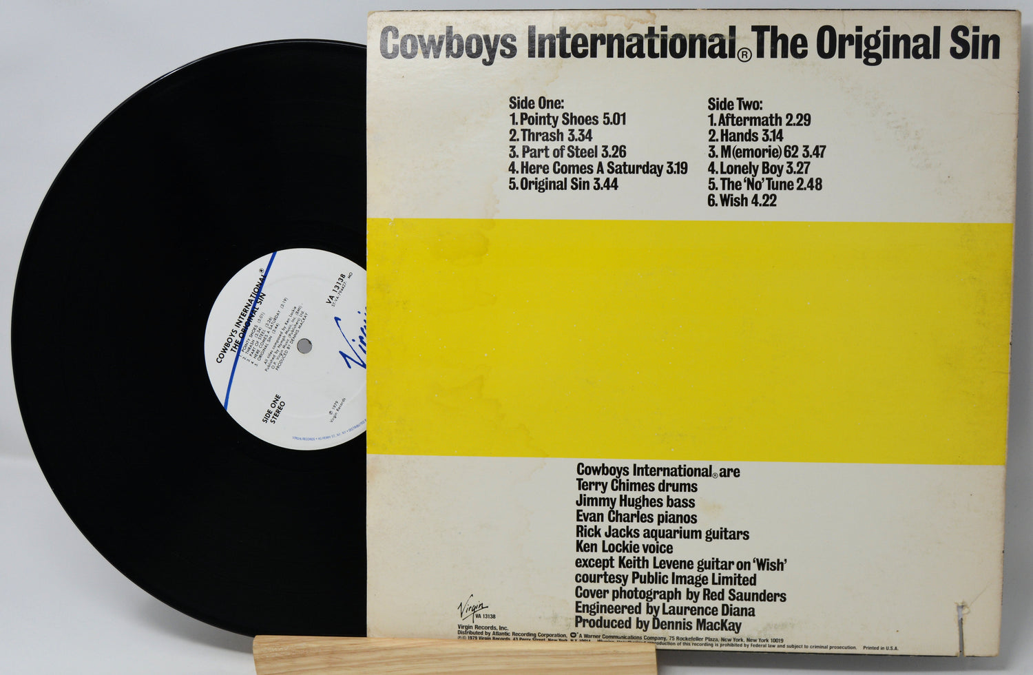 Vinyl record with yellow label and black text on a white background