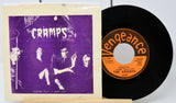 Vinyl record with 'The Cramps' cover and record label on a white background