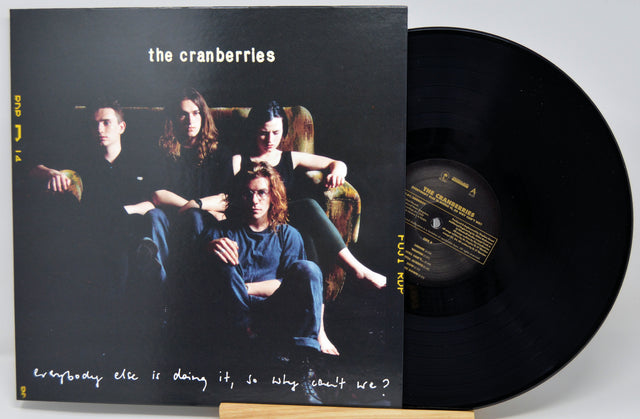 The Cranberries 'Everybody Else Is Doing It, So Why Can't We?' vinyl record LP with its black cover jacket and a partially visible black record on a light gray background.