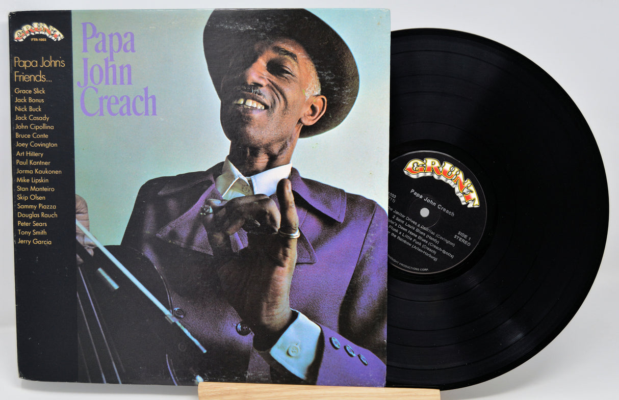 Vinyl record with cover featuring a man in a suit and hat, on a white background