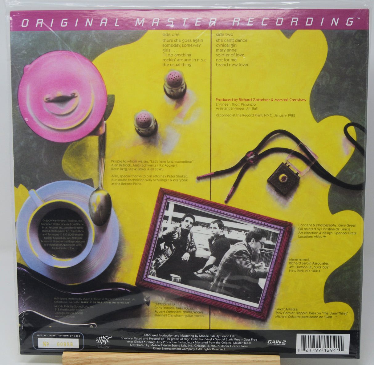 The back cover of a 60s vinyl record sleeve, featuring a collage of vintage objects including a pink plate, a blue teacup, a black camera, and a framed black-and-white photo on a yellow and gray background. The top banner reads 'ORIGINAL MASTER RECORDING'.