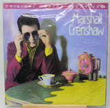 Marshall Crenshaw 'Original Master Recording' vinyl record cover, sealed in plastic shrink wrap, displayed on a small wooden stand against a light gray background.