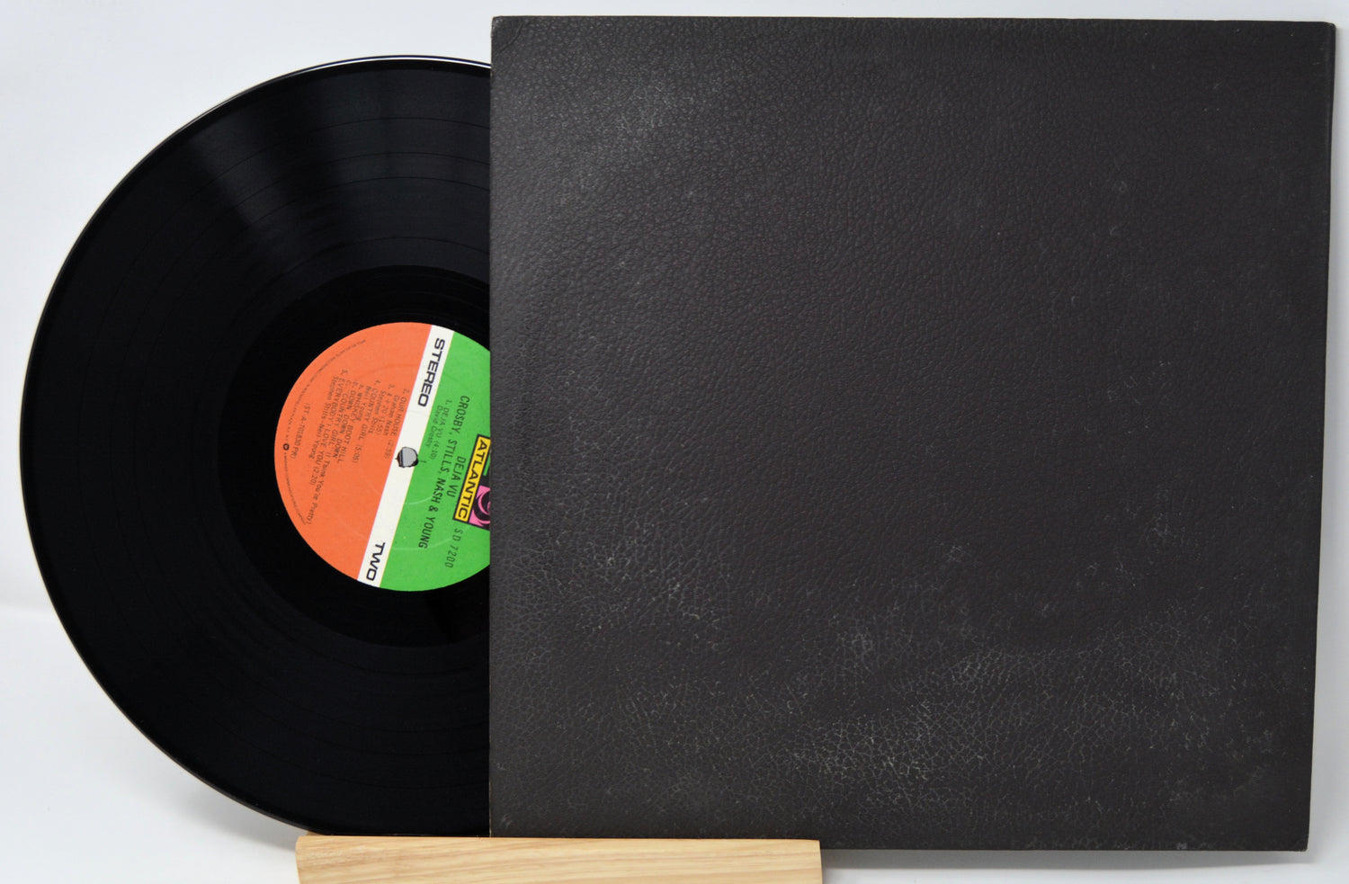 Vinyl record with a black cover on a white background