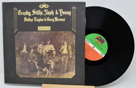 Vinyl record with a black cover featuring a group photo and a visible label.