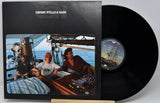 Crosby, Stills & Nash 'On A Sailboat' vinyl record LP with the black record partially pulled from its black sleeve, which features a color photo of the band on a sailboat.