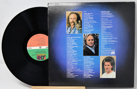 Vinyl record with cover featuring album tracklist and portraits on a white background
