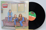 Vinyl record with cover showing three people on a couch, labeled 'Super Saver Series'.